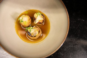 Wer an Sterneküche denkt, hat meist hochwertige Fleisch- oder Fischgerichte im Sinn. Dass auch vegetarische oder gar vegane Alternativen große Beliebtheit in der Königsklasse der Restaurants erreichen können, beweist Sternekoch Maximilian Moser vom Gourmetrestaurant Aubergine in Starnberg. Mit Techniken, die der 37-Jährige aus der klassischen Küche adaptiert und auf ein neues Level bringt, hat er die „Mittelmeerpilgermuschel“ neu kreiert, und das vollkommen pflanzenbasiert. „Das Rezept für die vegane Jakobsmuschel mit Senfkaviar ist genial und sehr authentisch im Geschmack. Würde man nicht wissen, dass das Gericht plant-based ist, würde man den Unterschied zur Meeresfrucht kaum bemerken – speziell was die Optik und Textur im Mund betrifft“, ist Moser überzeugt. Der Gastronom ist überregional bekannt für seine kulinarischen Interpretationen. So trägt das Gourmetrestaurant Aubergine im Hotel Vier Jahreszeiten Starnberg unter seiner Leitung seit 2014 durchgehend den einzigen Michelin-Stern im oberbayerischen Fünfseenland. Hier geht’s zum Rezept. www.aubergine-starnberg.de, www.vier-jahreszeiten-starnberg.de Foto (download): Eine spannende kulinarische Kreation teilt Maximilian Moser, Sternekoch des Hotels Vier Jahreszeiten Starnberg/Oberbayern mit seiner Interpretation einer veganen Jakobsmuschel. Bildnachweis: Hotel Vier Jahreszeiten Starnberg/Ben Döring