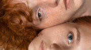 Portrait of beautiful redhead couple isolated on grey studio background. Concept of beauty, skin care, fashion and style