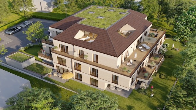 Mehrstöckiges Wohngebäude mit begrüntem Flachdach, Dachfenstern und umlaufenden Balkonen in ruhiger Umgebung. | Quelle: <a href="https://stauch-baugruppe.de/projekt/peretshofenerstrasse/" target="_blank" rel="noopener">Stauch Bau GmbH</a>